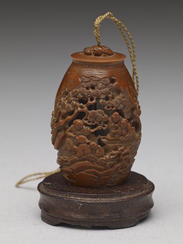 “Carved olive-pit pendant on the joy of fishermen in the shade of a pine