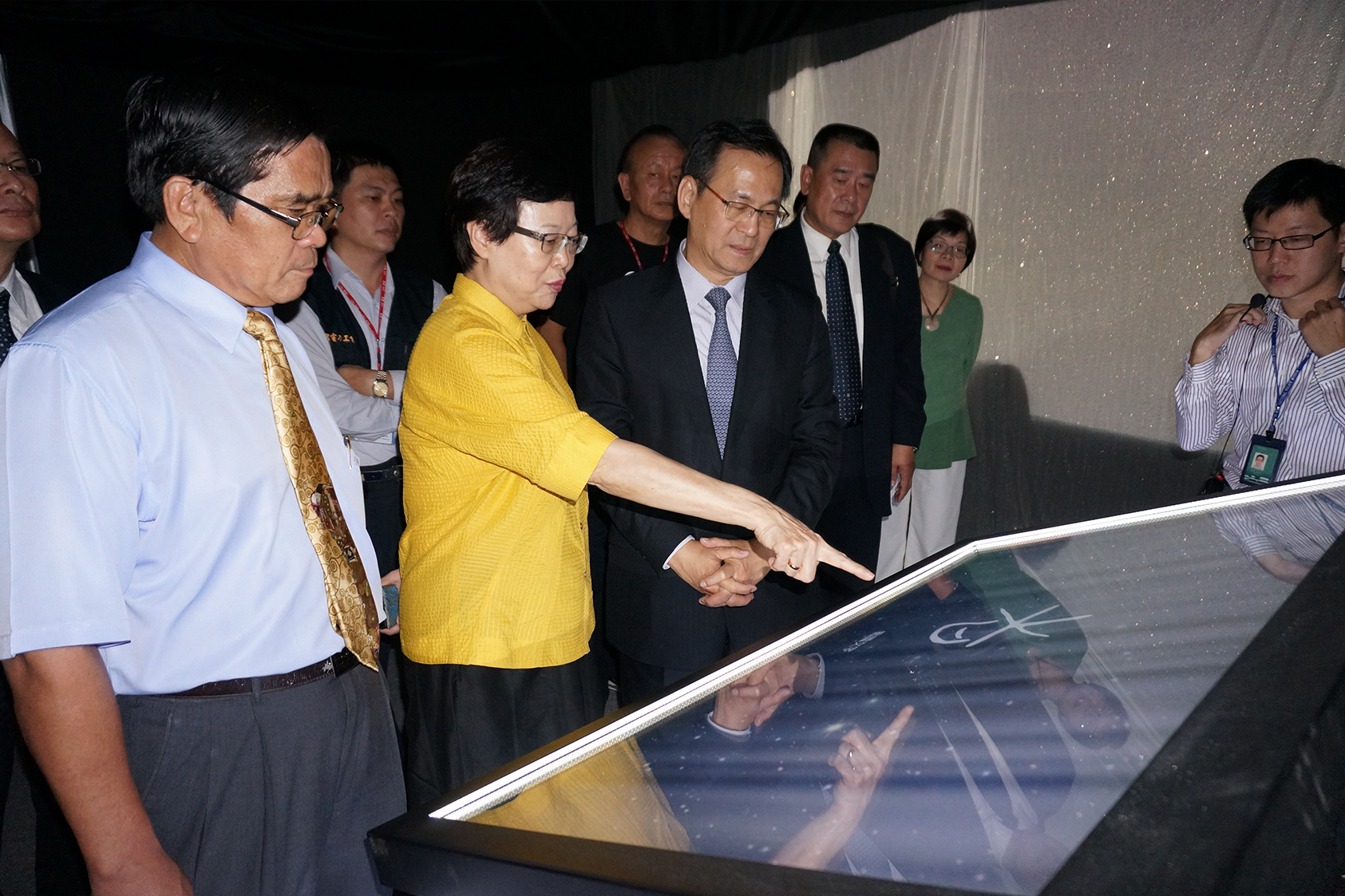NPM Director Fung Mingchu demonstrates how to use the Mao-Gong Ding Interactive Tabletop of Chinese Characters