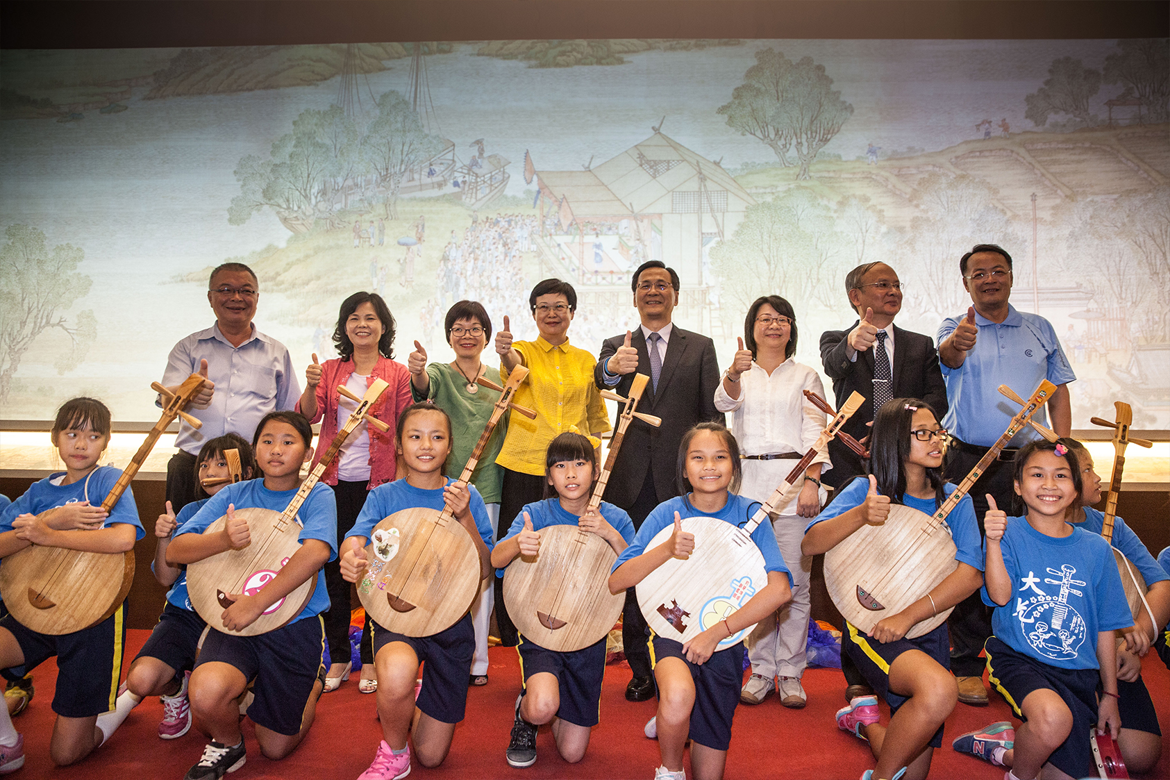 A group photo of NPM Director Fung Mingchu, Taipower Company Chairman Huang Zhongqiu, et al., and Daguang Elementary School folk ensemble