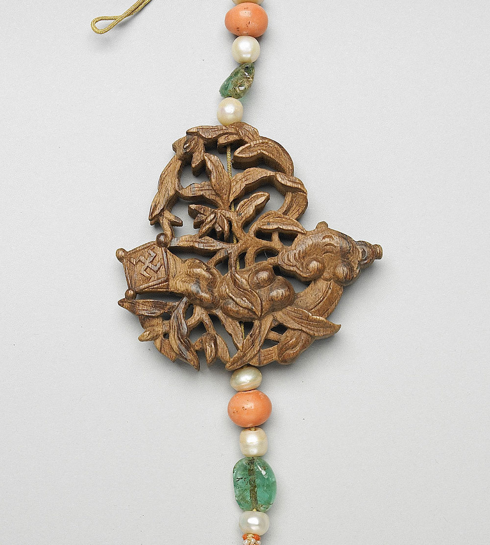 Carved agarwood scent pendant with characters for “All as You Wish”