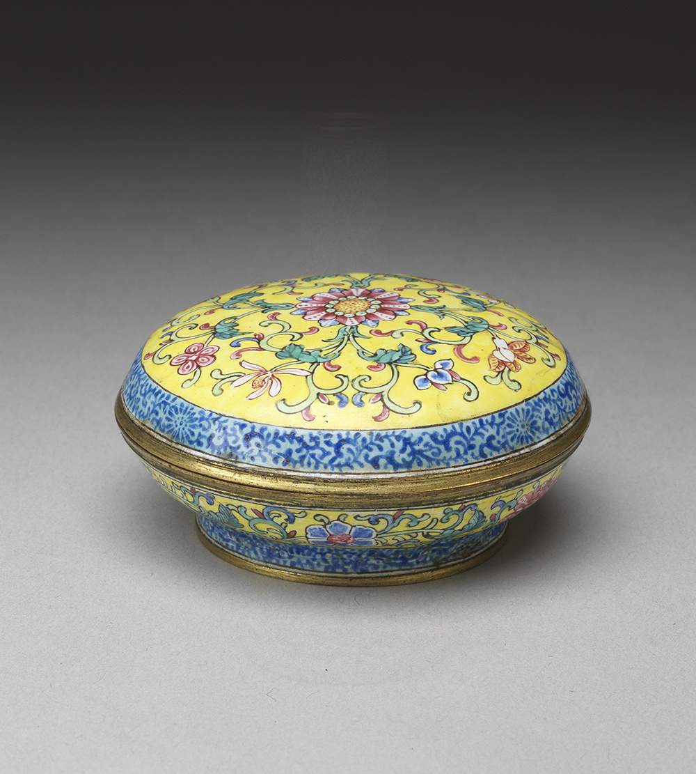 Painted enamel container with lotus decoration on a yellow background