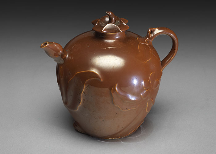 Porcelain peach-shaped teapot with a handle in brown glaze