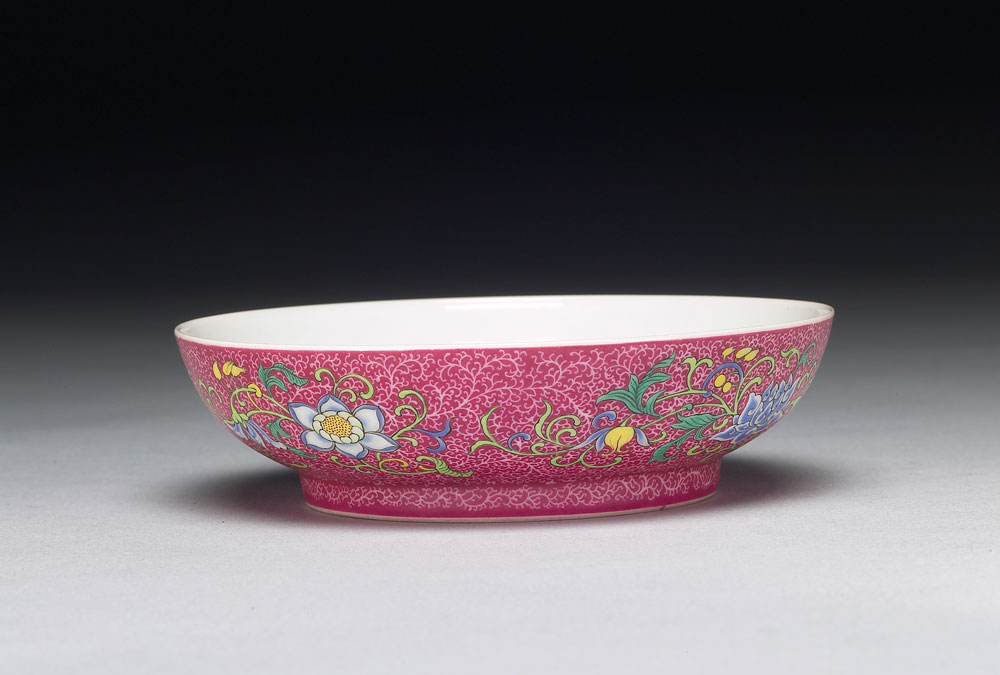 Dish with 'Three Plenty' motif on a polychrome red ground in yangcai painted enamels