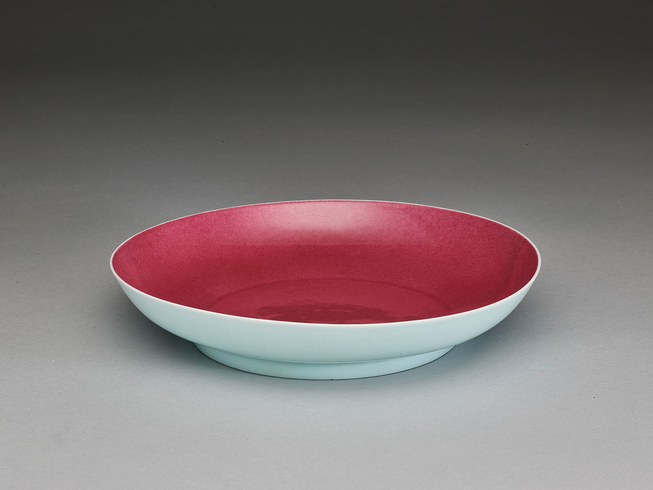 Saucer with sky-blue glaze on the exterior and incised dragons in rouge glaze on the interior Mark of xuande nian zhi