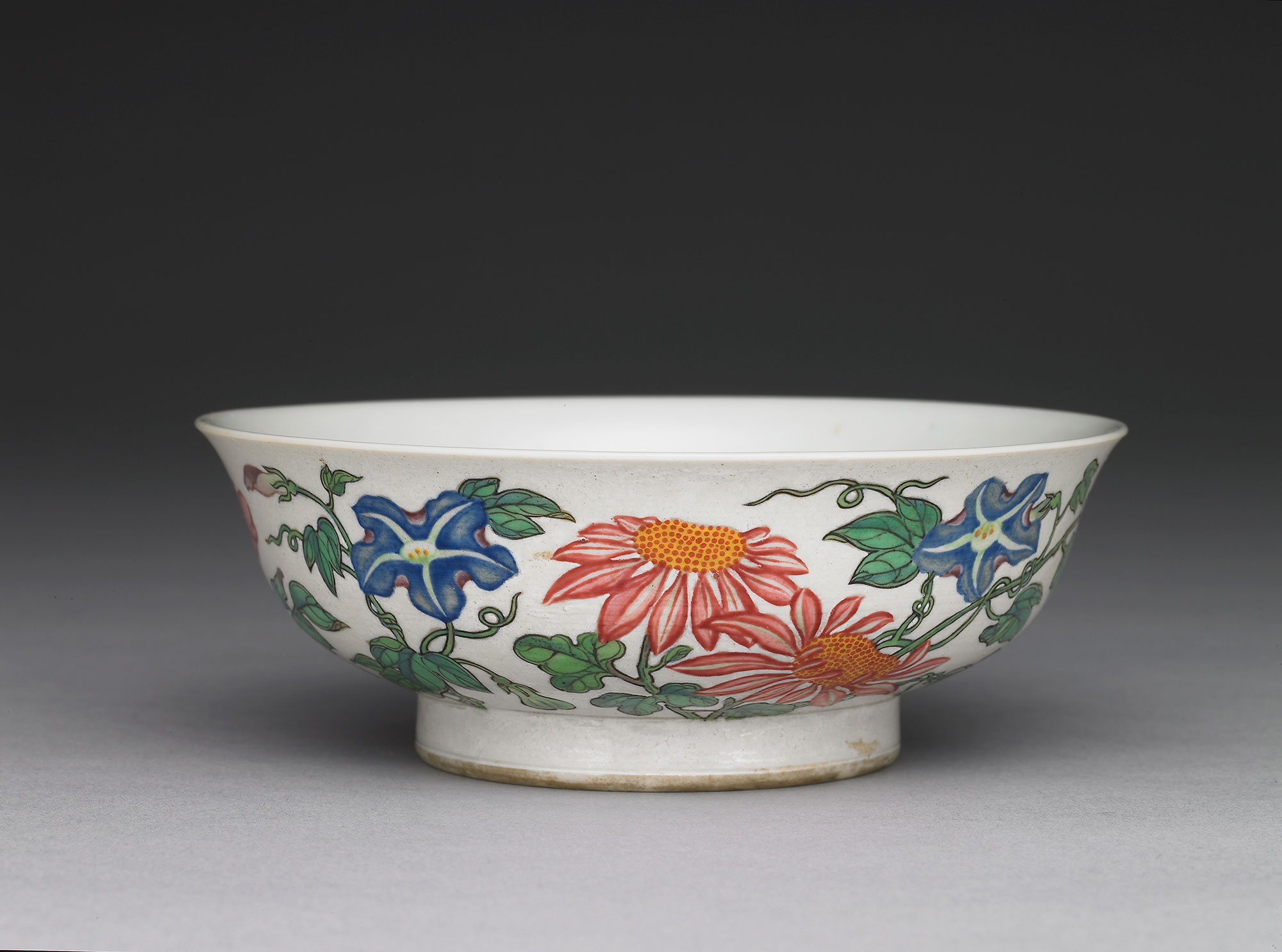 Bowl with flowers on a white ground in painted enamels