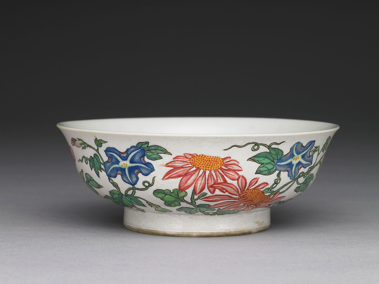 Bowl with flowers on a white ground in painted enamels