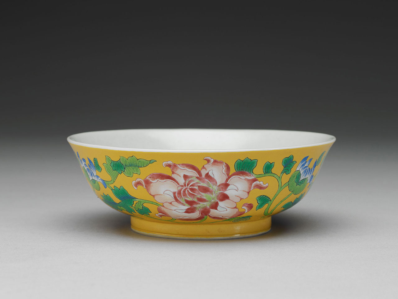 Bowl with flowers on a yellow ground in painted enamels