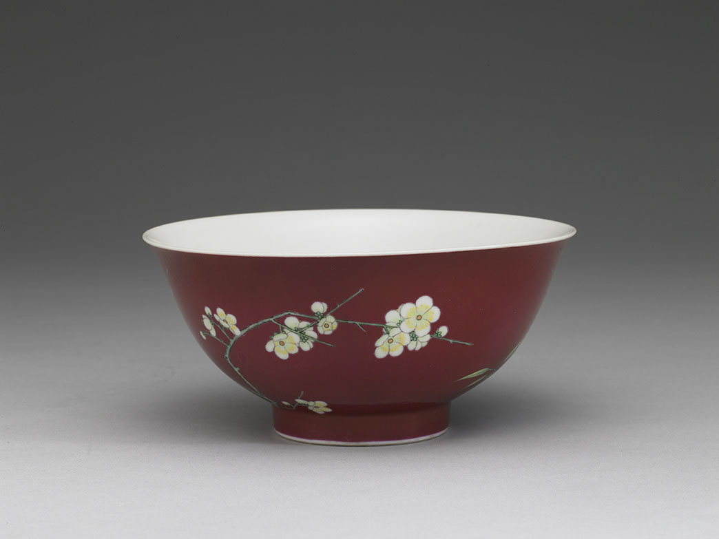 Bowl with plum blossoms and bamboo on a red ground in painted enamels