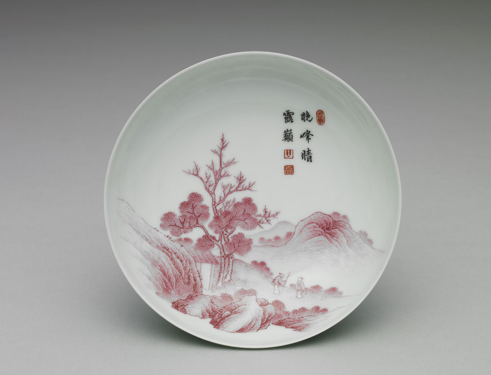 Dish with red landscape inside a carved green exterior in falangcai painted enamels