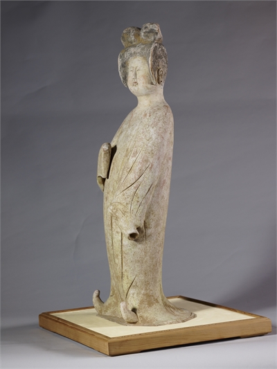Pottery figure of a standing lady with painted colors